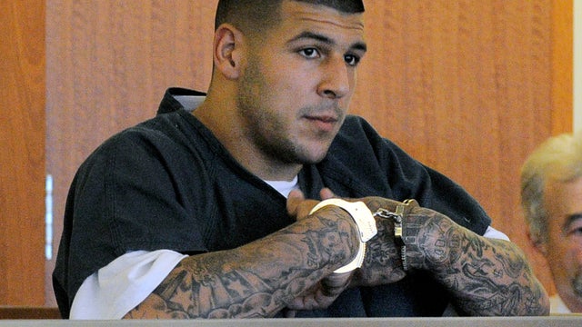 In December 2012 file photo, New England Patriots tight end Aaron Hernandez reacts during the second quarter of an NFL football game against the Houston Texans in Foxborough, Mass. State and local police spent hours at the home of New England Patriots tig 