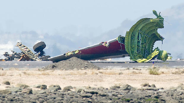 The detached tail and landing gear of Asiana Flight 214 rest on the tarmac after the plane crashed at San Francisco International Airport on Saturday, July 6, 2013, in San Francisco.  