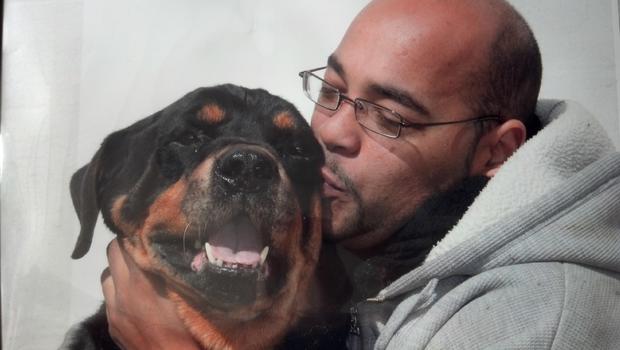 Yankees HOPE Week honoree Pedro Rosario with one of the dogs at his shelter 
