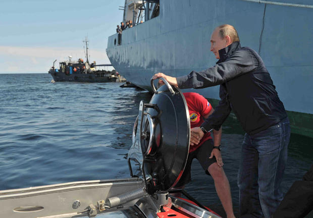 Russian President Vladimir Putin reacts after he submerged on board Sea Explorer 5 bathyscaphe off the island of Gogland 