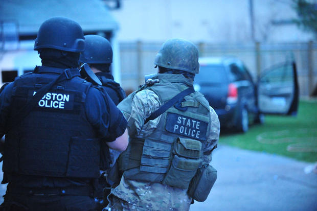 Law enforcement at the scene in Watertown, Mass., where Dzhokhar Tsarnaev is hiding on April 19, 2013. 