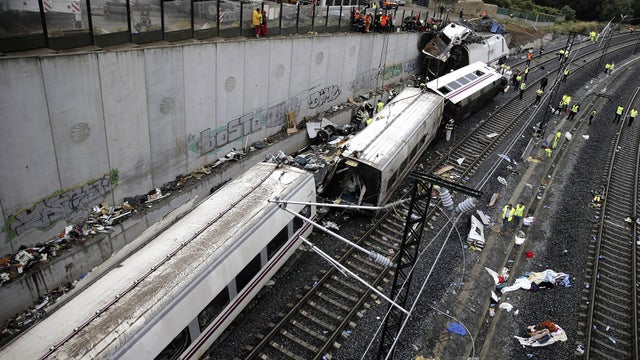 Rescuers, forensics and police officers work at the site of a train accident near the city of Santiago de Compostela, Spain, July 25, 2013. 
