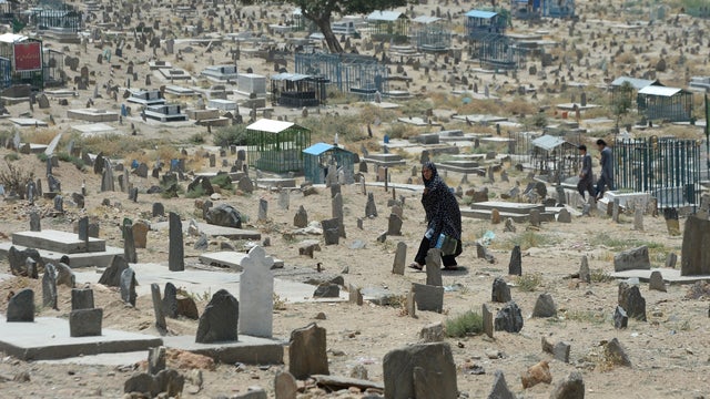 An Afghan woman walks in a cemetery in Kabul. 