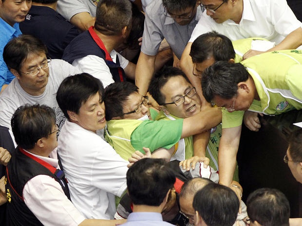 Ruling and opposition lawmakers fight on the legislature floor in Taipei, Taiwan, Aug. 2, 2013. 