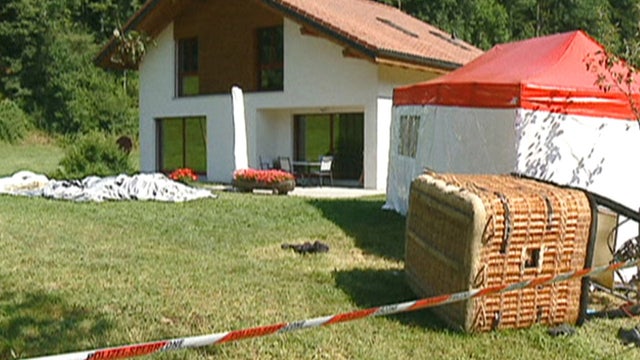 Swiss police examine the basket of a hot air balloon which crashed in the town of Montbovon 