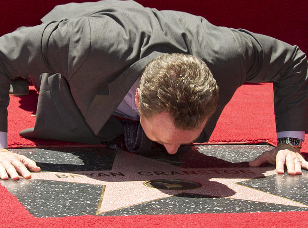 Actor Bryan Cranston gets up close with his newly unveiled star at the star presentation ceremony on the Hollywood Walk of Fame, July 16, 2013. 