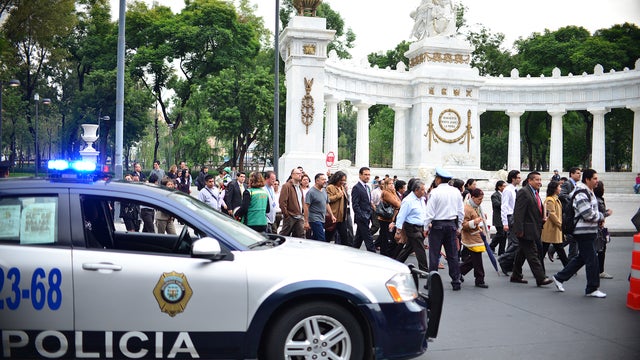 People evacuate buildings after a 6.2 magnitude earthquake shook Mexico City 