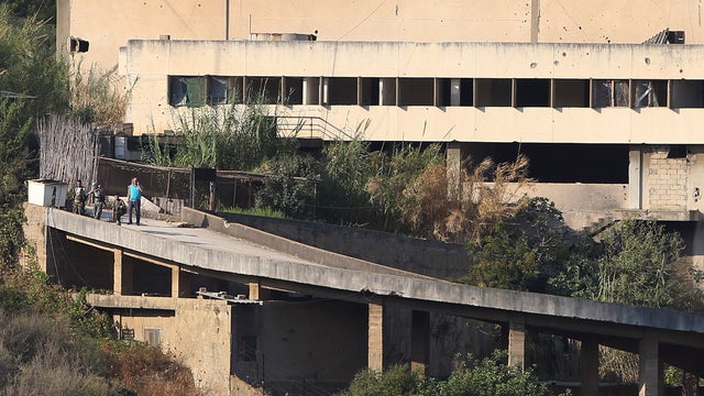 Gunmen from the Palestinian Popular Front for the Liberation of Palestine-General Command, stand outside their base 