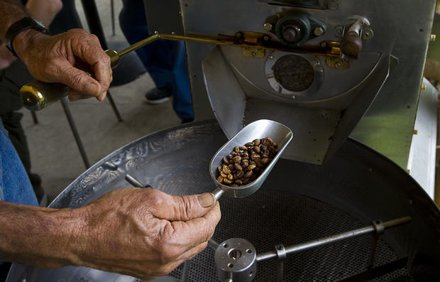 Farmer Rafael Jaramillo gets coffee from 