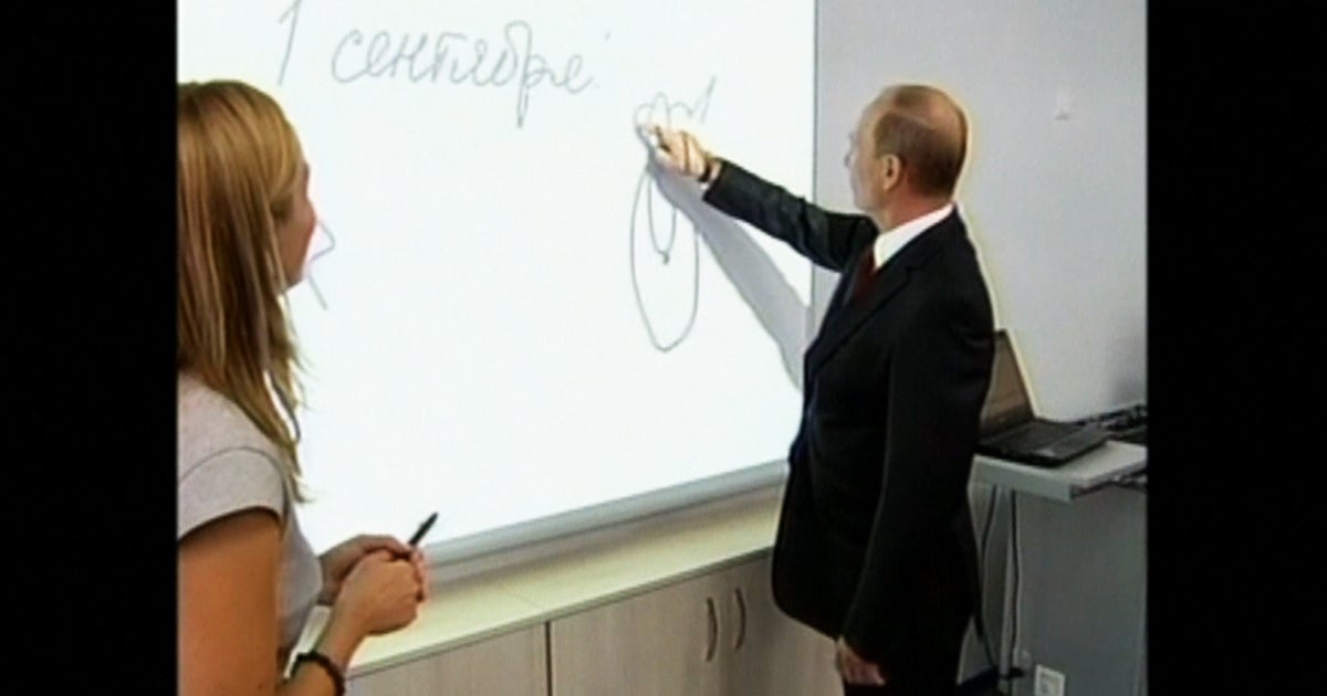 Putin tests his artistic skills during school visit - CBS News