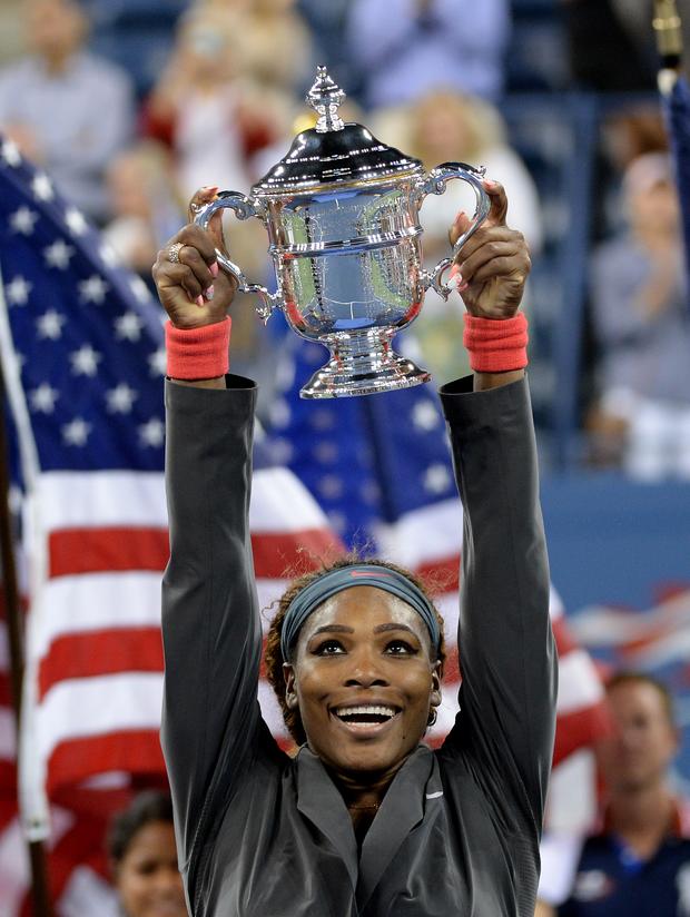 Serena Williams holds the trophy as she celebrates her win over Victoria Azarenka of Belarus during their 2013 US Open women's singles final match in New York City. 