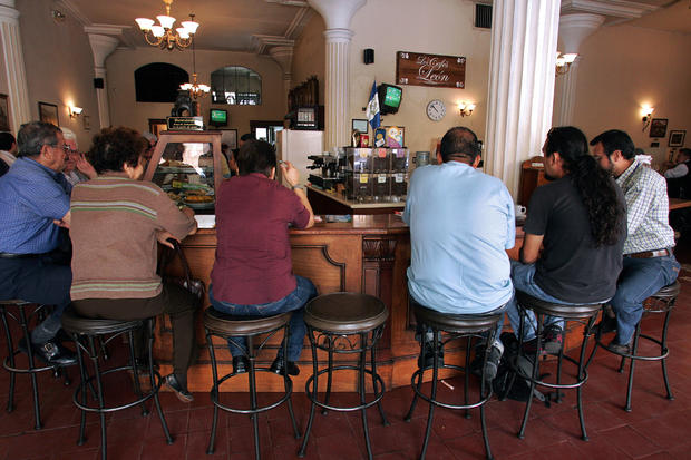 People sit at the bar of a coffee house 