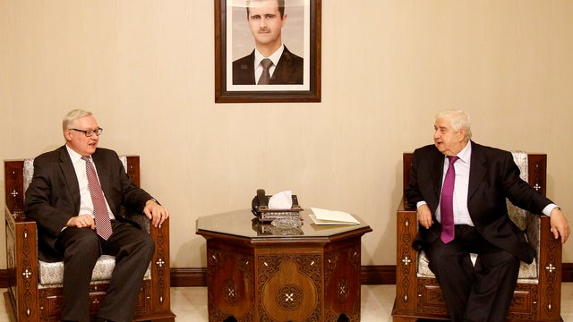 Syrian Foreign Minister Walid al-Moallem, right, meets Russian Deputy Foreign Minister Sergei Ryabkov 