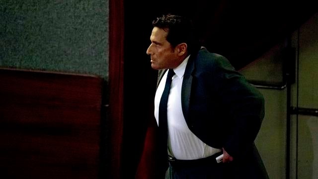Captain Francesco Schettino walks in the court room of the converted Teatro Moderno theater for his trial 