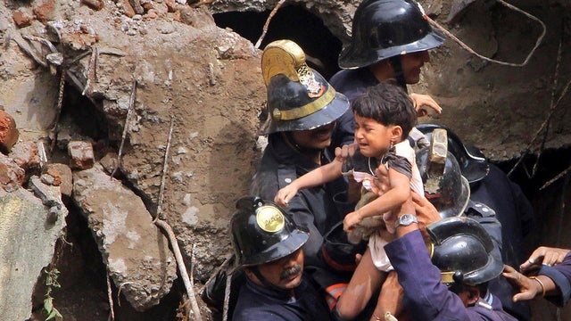 Indian Fire officials rescue a girl from debris 
