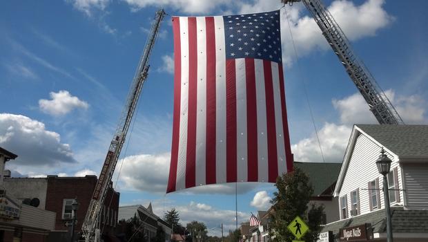 An American flag flies over Main Street in Ramsey, N.J. in honor of fallen Marine Tim McGill 