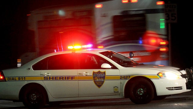 Police block the road to the Jacksonville International Airport terminal as a shuttle used to move people out of the airport drives by Tuesday, Oct. 1, 2013, in Jacksonville, Fla. The airport was evacuated after authorities found two suspicious packages. 