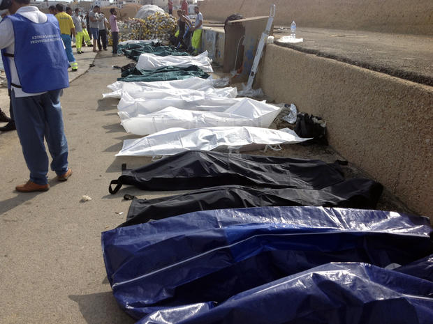 Bodies of drowned migrants are lined up in the port of Lampedusa, Italy, Oct. 3, 2013. 