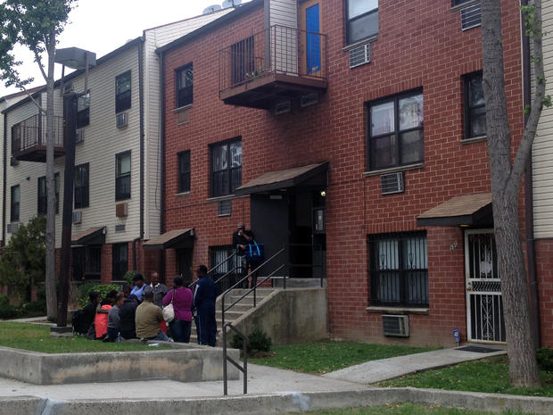 Family and friends of Margarine Lyons gather outside her Brooklyn home. 