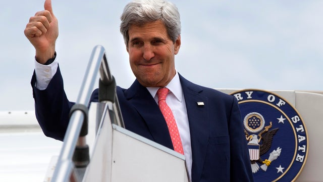 U.S. Secretary of State John Kerry gives a thumbs-up as he leaves Malaysia from outside of Kuala Lumpur, Malaysia, Oct. 11, 2013. 