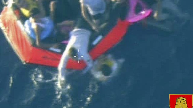 Migrants are seen aboard a liferaft after a boat carrying more than 200 migrants capsized off the Sicilian island of Lampedusa Oct. 11, 2013, in this picture released by the Maltese army. 