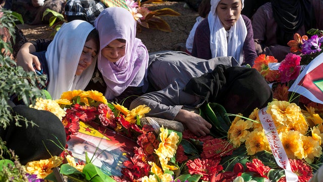 Kurdish women grieve Oct. 15, 2013, during a visit to the Martyrs' cemetery to remember those who died in Syria's civil war in the Syrian Kurdish town of Derik on the first day of Eid al-Adha, which commemorates the willingness of Abraham to sacrifice his 