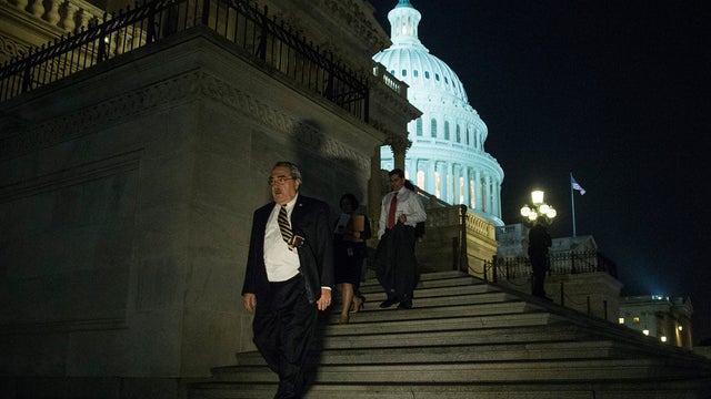 Rep. G. K. Butterfield (D-NC) walks down the steps of the House side of the Capitol building after a bipartisan bill was passed by the House and Senate to reopen the government and raise the debt limit 
