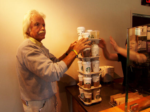 Dan buys a towering stack of coffees. 