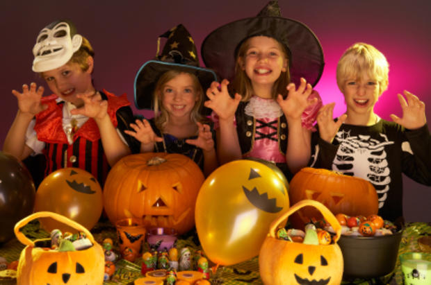 Halloween party with children wearing fancy costumes 