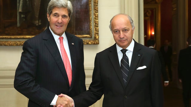 French Foreign Minister Laurent Fabius shakes hands with U.S. Secretary of State John Kerry  