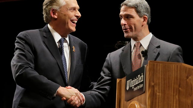 Democratic gubernatorial candidate Terry McAuliffe, left, shakes the hand of Republican candidate Ken Cuccinelli, right, after a debate at Virginia Tech in Blacksburg, Va., Thursday, Oct. 24, 2013. 