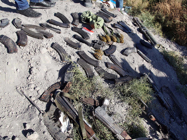 Weapons and ammunition are seen on the ground that were carried by Syrian rebels who were killed by Syrian government forces, according to the Syrian official news agency SANA, near the Otaiba area near Damascus, Syria, Oct. 25, 2013, in this picture released by SANA. 