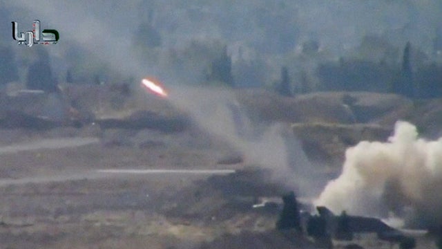 A rocket soars through the air in Daraya on the outskirts of Damascus 