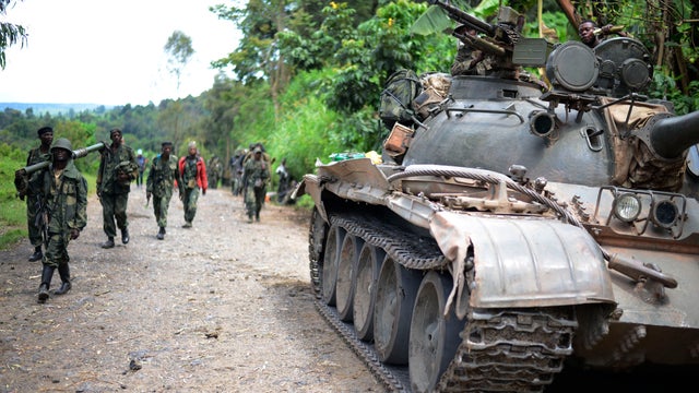 Congolese army soldier advance toward Bunagana, Congo, through formerly rebel-held territory 