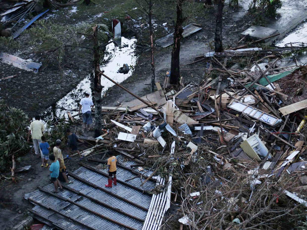 Residents sift through the rubble of their damaged house following a powerful typhoon that hit Tacloban on hardest-hit Leyte Island in the Philippines Nov. 9, 2013. 