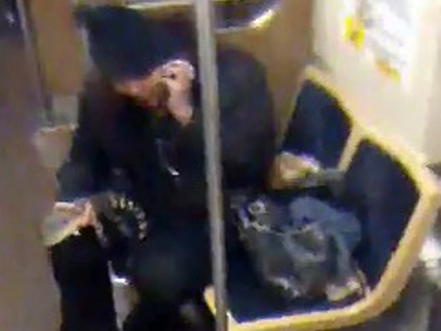 A woman with a 2-foot-long alligator is seen aboard a Chicago Transit Authority Blue Line train early Nov. 1, 2013, in Chicago in this security camera image provided by the CTA Nov. 13, 2013. 