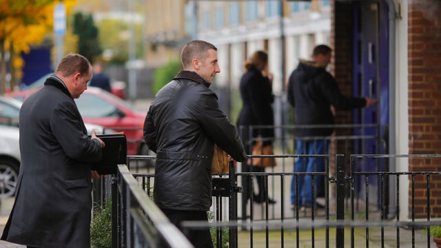Detectives from CID conduct house-to-house interviews in a South London block of flats that is being investigated in connection with an alleged slavery case 