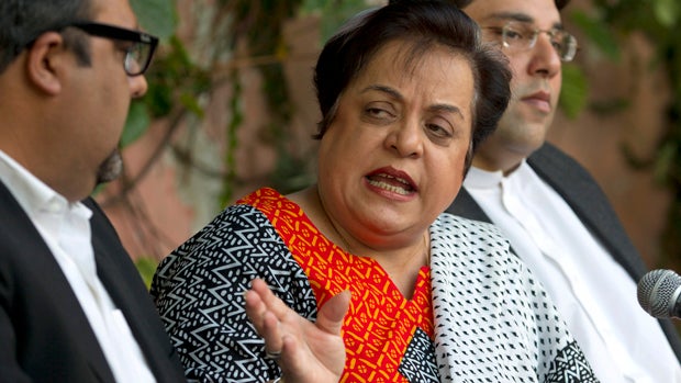 Shireen Mazari, center, information secretary of the Pakistan Tehreek-e-Insaf party, addresses a news conference with party officials in Islamabad Nov. 27, 2013. 