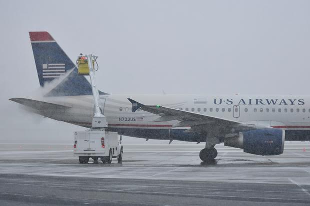 A worker at Lehigh Valley International Airport works on deicing and anti-icing an aircraft 
