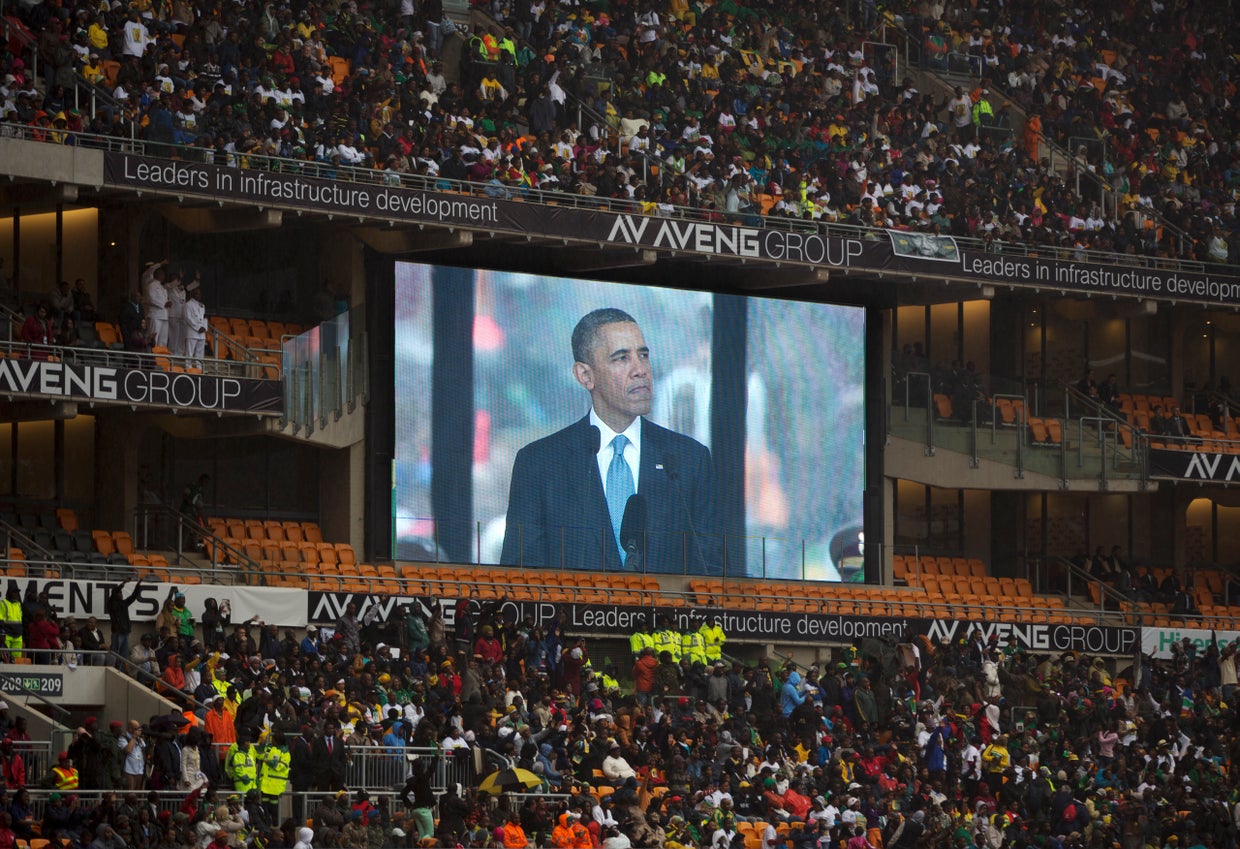 President Obama speaks to mourners attending the memorial service for former South African president Nelson Mandela at the FNB Stadium in Soweto near Johannesburg 