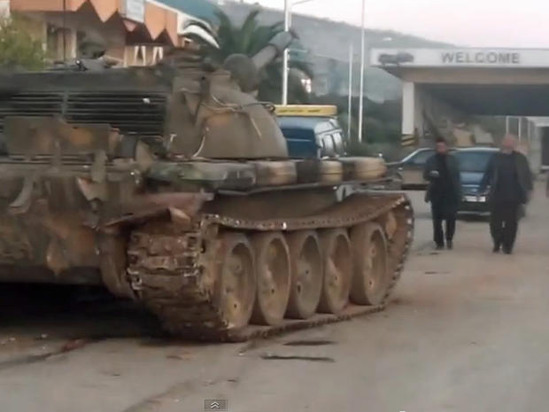 A Syrian military tank, commandeered by rebels loyal to the Western-backed opposition Supreme Military Council, is seen in front of the Bab al-Hawa border crossing with Turkey 