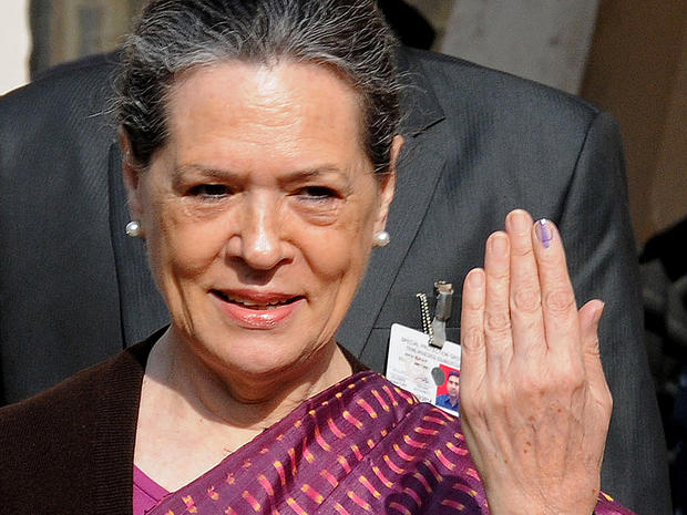 India's Congress Party president Sonia Gandhi poses with her ink-marked finger after casting her vote in the Delhi state assembly election in New Delhi, Dec. 4, 2013. 