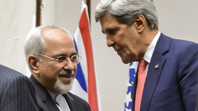 Iranian Foreign Minister Mohammad Javad Zarif shakes hands with US Secretary of State John Kerry 