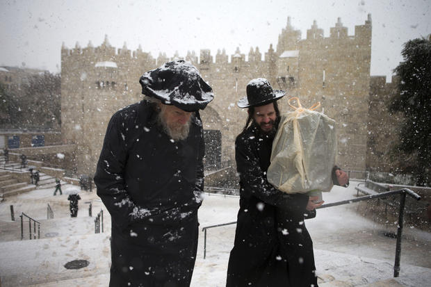 Ultra orthodox jews walk past the Damascus gate outside Jerusalem's old city 