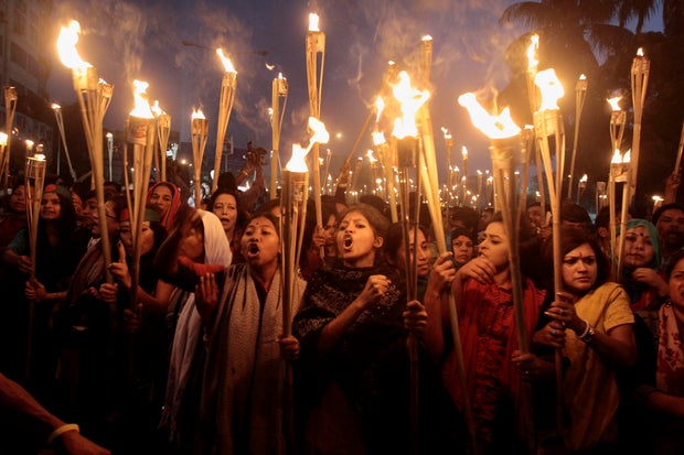 Bangladeshi activists shout slogans as they participate in a torch rally in Dhaka, Bangladesh.