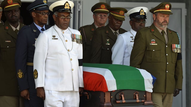 The coffin of South African former president Nelson Mandela leaves the funeral ceremony for a traditional burial in his ancestral village of Qunu 