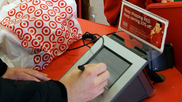 January 2008 file photo shows customer signing his credit card receipt at a Target store in Tallahassee, Fla.; Target says some 40 million credit and debit card accounts may have been affected by a data breach that occurred at its U.S. stores between Nov. 