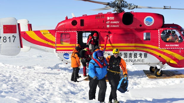 The first group of passengers of the trapped Russian ship MV Akademik Shokalskiy arrive at a safe surface off the Antarctic ice Jan. 2, 2014, in this picture provided by China's official Xinhnua News Agency. 