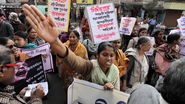 Indian activists shout slogans as they protest against the gang rape of a 21-year-old woman in the city in Kolkata 