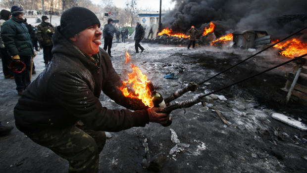 Protesters use a large slingshot to hurl a Molotov cocktail at police in central Kiev, Ukraine, Jan. 23, 2014. 